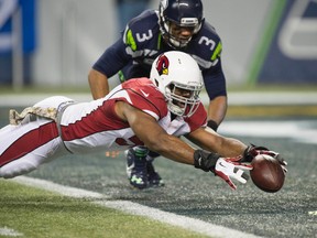 Arizona Cardinals linebacker Alex Okafor dives for a fumble by Seattle Seahawks quarterback Russell Wilson during the second quarter at CenturyLink Field. (Troy Wayrynen/USA TODAY Sports)