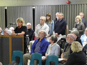 Residents line up to voice their opinions to a plan by CaraCo Development Corporation to increase the number of units in its Stone and South on the River condominium development. (Wayne Lowrie/Postmedia Network)
