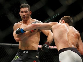 Chris Weidman, left, fights Luke Rockhold in a middleweight championship bout at UFC 194 Saturday, Dec. 12, 2015, in Las Vegas. (AP Photo/John Locher)