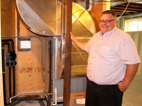 Derek Trudgen, hydronic design and geothermal expert with Postma Heating and Cooling, displays a geothermal heating and cooling system that has been installed in Chatham, Ont. area home. Photo taken on Tuesday May 17, 2016. (Ellwood Shreve, The Daily News)