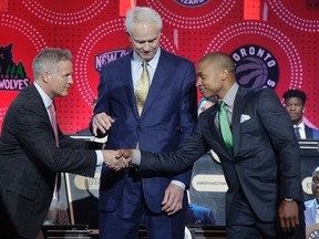 Philadelphia 76ers head coach Brett Brown, left, is congratulated by Boston Celtics guard Isaiah Thomas, right, and Los Angeles Lakers general manager Mitch Kupchak after the 76ers won the top draft pick during the NBA basketball draft lottery, Tuesday, May 17, 2016, in New York. (AP Photo/Julie Jacobson)
