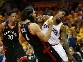 Raptors forward Luis Scola, getting some rare playing time in the playoffs, fouls Cleveland Cavaliers’ Iman Shumpert on Tuesday night. (JACK BOLAND/Toronto Sun)