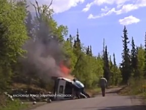 A still image of a dramatic rescue in Anchorage, Alaska by a police officer and Good Samaritans. (YouTube/Screengrab)