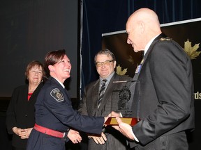 Const. Cheryl Kennelly of the Greater Sudbury Police Service receives the meritorious action award from Chief Paul Pedersen at the Community and Police Awards Gala in 2016. (Gino Donato/Sudbury Star file photo)