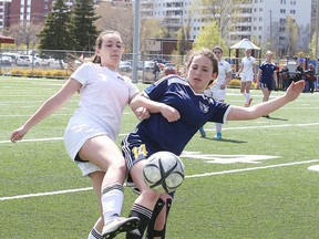 Marymount Academy Regals' Mackenzie Watkins and Notre Dame Alouettes' Chanelle Lafortune battle for the ball during senior girls high school playoff action in Sudbury, Ont. on Tuesday May 17, 2016. Gino Donato/Sudbury Star/Postmedia Network