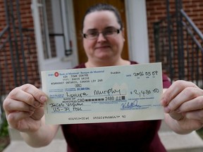 Emily Mountney-Lessard/The Intelligencer
Belleville woman Laura Murphy with a bank draft she received as part of an online scam recently. She's shown here on Tuesday in Belleville.