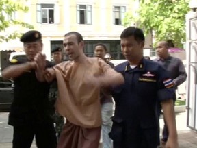Still image taken from video shows Adem Karadag, also known as Bilal Mohammed, a suspect in last year's Bangkok blast, shouting as he is escorted to court in Bangkok, Thailand, May 17, 2016. REUTERS TV