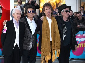 Members of the band The Rolling Stones, from left, Charlie Watts, Ronnie Wood, Mick Jagger and Keith Richards pose for photographers upon arrival at the Rolling Stones Exhibitionism preview in London, Monday, April 4, 2016. (Photo by Joel Ryan/Invision/AP)