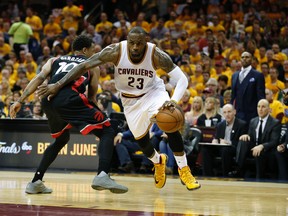 Cleveland Cavaliers' LeBron James pushes off on Toronto Raptors' DeMar DeRozan in the third quarter at Quicken Loans Arena in Cleveland on May 18, 2016. (Jack Boland/Toronto Sun/Postmedia Network)