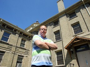 Matthew Komus, a volunteer guide with Doors Open Winnipeg, stands outside the Vaughan Street Jail. Komus will be leading a Haunted History walking tour of the area later this month. (Brian Donogh/Winnipeg Sun)
