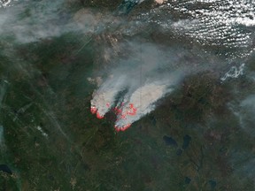 NASA's satellite image shows columns of smoke rising up from the myriad of wildfires, with NASA outlining actively burning areas in red over the Fort McMurray, Alberta, Canada on May 16, 2016.   Courtesy NASA/Handout via REUTERS  ATTENTION EDITORS - THIS IMAGE WAS PROVIDED BY A THIRD PARTY. EDITORIAL USE ONLY.  TPX IMAGES OF THE DAY