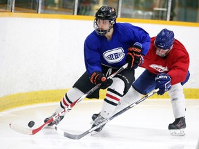 Players battle for the puck during a scrimmage at the Rayside Canadians tryout camp at the Gerry McCrory Countryside Sports Complex in Sudbury, Ont. on Sunday May 15, 2016. Gino Donato/Sudbury Star/Postmedia Network
