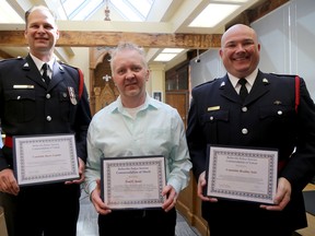 Emily Mountney-Lessard/The Intelligencer
Belleville Police Services Cst. Barry Lannin (left) and Cst. Brad Stitt (right) are photographed with civilian Paul Jones after receiving commendations for their life-saving actions during events earlier this year. They are shown here at the police services board meeting on Wednesday.