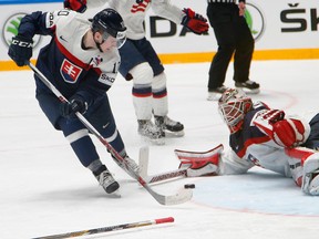 Slovakia’s Martin Reway (left) attacks the U.S. net as goaltender Keith Kinkaid sprawls across the ice during world hockey championship action in St. Petersburg, Russia, on Tuesday, May 17, 2016. (Dmitri Lovetsky/AP Photo)