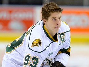 London Knights forward Mitch Marner plays with the puck while waiting for a photo session prior to a team practice at Budweiser Gardens in London on May 6, 2016. (MORRIS LAMONT/THE LONDON FREE PRESS)