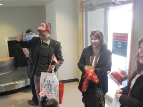 Fares Albonai gives thumbs up to supporters as his wife Ossaima smiles. (Wayne Lowrie/Postmedia Network)