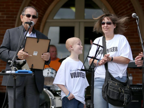 Intelligencer file photo
City of Belleville Councillor Garnet Thompson makes a presentation to the Martin family prior to the 10-hour benefit concert in their honour, Sunday, Aug. 17, 2014. Thomas Martin’s parents are questioning why they were asked not to discuss their son at a recent Pedal for Hope event at Queen Elizabeth School.