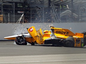 The car driven by Spencer Pigot slides along the track after hitting the wall in the first turn during a practice session for the Indianapolis 500 auto race at Indianapolis Motor Speedway in Indianapolis, Wednesday, May 18, 2016. (AP Photo/Tom Hemmer)