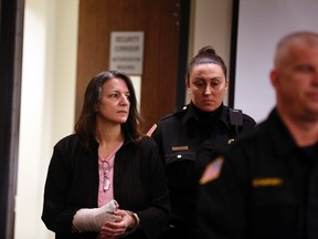 Michelle Lodzinski enters the courtroom in New Brunswick, N.J., Friday, March 18, 2016. On May 18, Lodzinski was convicted of killing her five-year-old son, Timothy, more than 20 years ago. (Patti Sapone/NJ Advance Media via AP, Pool)