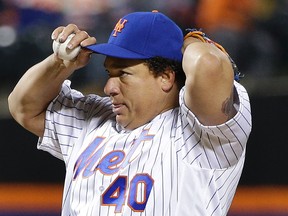 New York Mets pitcher Bartolo Colon adjusts his cap after giving up a base hit to Cameron Rupp of the Philadelphia Phillies during the fifth inning of a game in New York on April 9, 2016. (AP Photo/Julie Jacobson)