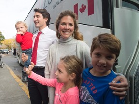 Justin Trudeau, his wife Sophie Gregoire Trudeau and children Hadrien, Ella-Grace and Xavier pose for photographers before boading the campaign bus after voting in Montreal on October 19, 2015. The opposition parties are making some political hay over media reports that Prime Minister Justin Trudeau's wife wants extra staff to help manage her official duties. THE CANADIAN PRESS/Adrian Wyld