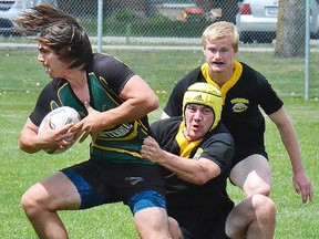 Trenton loose forward Matt Tedford corrals a Centennial Chargers ballcarrier during Bay of Quinte senior boys rugby finals action Wednesday at MAS Park Field 4. (Catherine Frost for The Intelligencer)