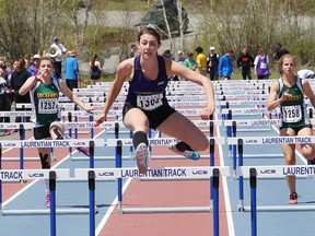 Michelle Corallo, middle, of Lo-Ellen Park Secondary School, competes in the senior girls 100 metre hurdles finals at the local high school track and field championships at the track at Laurentian University in Sudbury, Ont. on Wednesday May 18, 2016. John Lappa/Sudbury Star/Postmedia Network