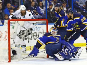 St. Louis Blues goalie Brian Elliott looks for the puck as he falls to the ice while center Kyle Brodziak looks to clear the rebound during the second period in game two of the Western Conference Final of the 2016 Stanley Cup Playoff against the San Jose Sharks, at Scottrade Center. The Sharks won the game 4-0. (Billy Hurst/USA TODAY Sports)