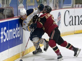 West Kelowna Warriors’ Liam Blackburn pins Bryce Van Horn of the Carleton Place Canadians into the boards yesterday during RBC Cup action in Lloydminster, Sask. (Eric Healey, Postmedia Network)