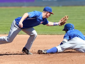 Daniel Bick (left) of the Ottawa Champions tags out teammate Robert Garza during practice. (Jean Levac, Postmedia Network)