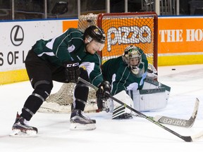 London Knights goaltender Tyler Parsons tracks the puck as forward Max Jones rounds his net during a team hockey practice at Budweiser Gardens in London, Ont. on Tuesday. The Knights head coach, Dale Hunter, and Red Deer Rebels head coach Brett Sutter did battle many times as opposing NHL centres. (Craig Glover)