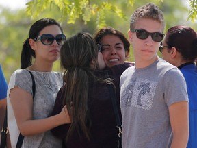 Unidentified relatives and friends of passengers who were flying in an EgyptAir plane that vanished from radar en route from Paris to Cairo react as they wait outside the EgyptAir in-flight service building where relatives are being held at Cairo International Airport, Egypt, on May 19, 2016. (REUTERS/Amr Abdallah Dalsh)