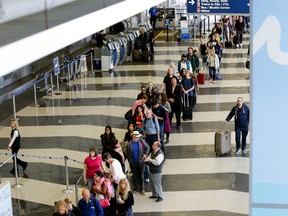 A long line of travellers wait for the TSA security check point at O'Hare International airport, Monday, May 16, 2016, in Chicago. Already faced with lines that snake through terminals out to the curb, fliers are bracing for long waits at security in the busy months of July and August. (AP Photo/Teresa Crawford)