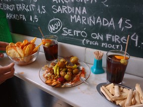 Standing at a bar with a sampler of tapas and chalkboard specials on the wall is a quintessential Spain experience. (photo: Rick Steves)