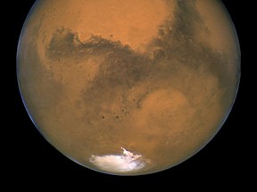 This Aug. 26, 2003 image made available by NASA shows Mars as it lines up with the Sun and the Earth. Photographed by the Hubble Space Telescope, it was about 55.8 million kilometers (34.6 million miles) from Earth. (NASA/J. Bell - Cornell U./M. Wolff - SSI via AP)