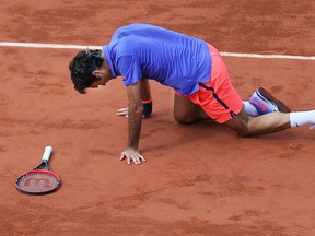 In this June 2, 2015 file photo, Switzerland's Roger Federer gets up after slipping in the quarterfinal match of the French Open tennis tournament against Switzerland's Stan Wawrinka at the Roland Garros stadium, in Paris, France. (AP Photo/David Vincent, File)