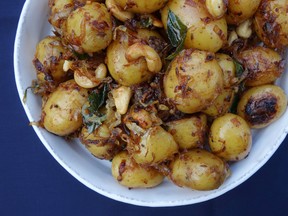 This May 15, 2016 photo shows South Indian potatoes in London. They are a distant, more tropical cousin of the classic potato salad but embellished with coastal Indian ingredients: crispy shallots, a few spices, crunchy golden cashews and a little coconut milk. (AP Photo/Meera Sodha)