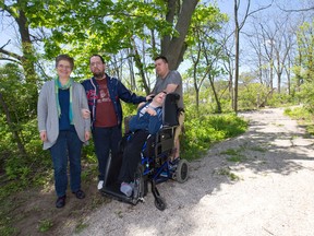 L'Arche London community leader and executive director Marietta Drost, left, clients Mike Hoadley and Paul Dupuis, and day program assistant Shawn Bates, stand at the entrance to a woodlot they will turn into accessible walking trails thanks to a Sparks! grant, on Colonel Talbot Road at Sunray Avenue in London, Ont. on Thursday May 19, 2016. (CRAIG GLOVER, The London Free Press)