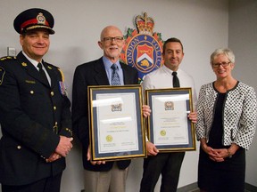 London Police chief John Pare stands with Michael Gregson and Derek Flynn who were awarded for helping a child who was stabbed. (MIKE HENSEN, The London Free Press)