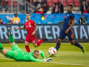 TFC’s Sebastian Giovinco is thwarted by New York City FC goalkeeper Josh Saunders as New York’s Ethan White looks on during the first half of Wednesday’s 1-1 draw at BMO Field. The hosts would have benefited from additional midfield support. (THE CANADIAN PRESS/PHOTO)