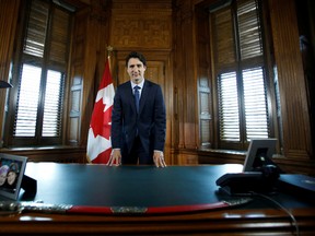 Prime Minister Justin Trudeau poses at his desk following an interview with Reuters in his office on Parliament Hill in Ottawa on May 19, 2016. REUTERS/Chris Wattie