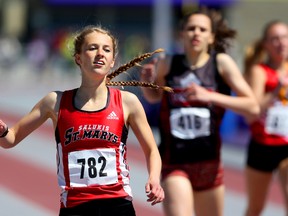 Natalie Topp of St. Marys wins the senior girls 400m ahead of Megan Beaudry of Lord Dorchester and Tatiana Desender of Saunders (right) on the first day of the WOSSAA track and field meet at TD Stadium on Thursday. (MIKE HENSEN, The London Free Press)