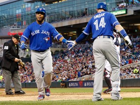 Toronto Blue Jays slugger Edwin Encarnacion, left, is congratulated by Justin Smoak after his two-run home run against the Minnesota Twins Thursday, May 19, 2016, in Minneapolis. (AP Photo/Jim Mone)