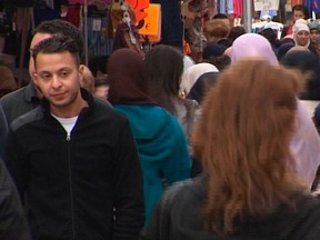 This file image taken from video and first released on April 13, 2016, shows Salah Abdeslam, left, the fugitive from the Nov. 13 Paris attacks whose capture appears to have precipitated the March 22 bombing in Brussels. Belgian prosecutors confirmed April 27, 2016, that Paris attacks suspect Salah Abdeslam was handed over to French authorities.  (TVbrussels via AP)