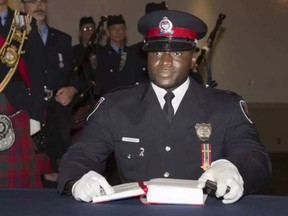 Const. Christian Nungisa receives his wallet badges at a 2013 ceremony. CHRIS MIKULA / THE OTTAWA CITIZEN