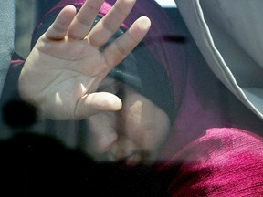 A relative of a passenger on an EgyptAir flight that crashed early Thursday puts her hand on the window from inside a bus at Cairo International Airport, Egypt, Thursday, May 19, 2016. Foreign Affairs Minister Stephane Dion says that Global Affairs Canada is providing consular assistance to the families of two Canadian citizens on board EgyptAir flight MS804 and officials are working closely with authorities to confirm whether there were any additional Canadian citizens on board. THE CANADIAN PRESS/AP-Ahmed Abd el Fattah