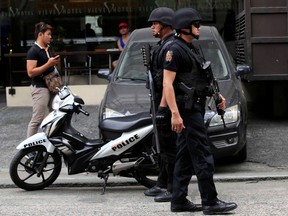 Members of the Philippine National Police (PNP) Special Weapons And Tactics (SWAT) patrol along a main street of metro Manila in the Philippines May 12, 2016. REUTERS/Romeo Ranoco