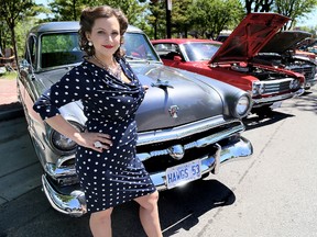 Miss RetroFest 2015, Kristi Denoot, poses with a 1953 Ford Customline  along King Street in Chatham. The 16th edition of the annual celebration of North America's car culture and history returns to Downtown Chatham on May 27 and 28.
File photo/Chatham Daily News