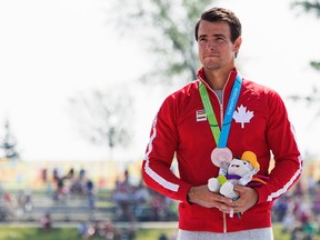 Canada's Adam van Koeverden accepts his bronze medal for the K1 1000m final at the Pan Am Games in Welland, Ont., on July 13, 2015. (THE CANADIAN PRESS/Aaron Lynett)