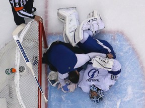 Tampa Bay Lightning goalie Ben Bishop lies on the ice after being injured during the first period of Game 1 against the Pittsburgh Penguins in Pittsburgh on May 13, 2016. (AP Photo/Gene J. Puskar)